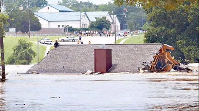 Floodwaters surrounding buildings in the Texas Hill Country